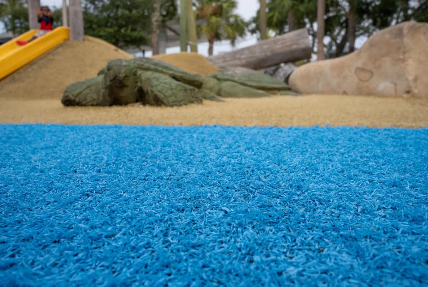 Daycare playground with a numbered hopscotch snake on artificial grass